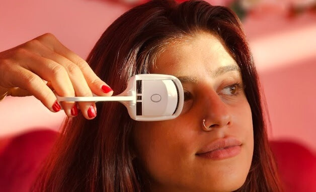 an Amara Client using Heated eyelash curler